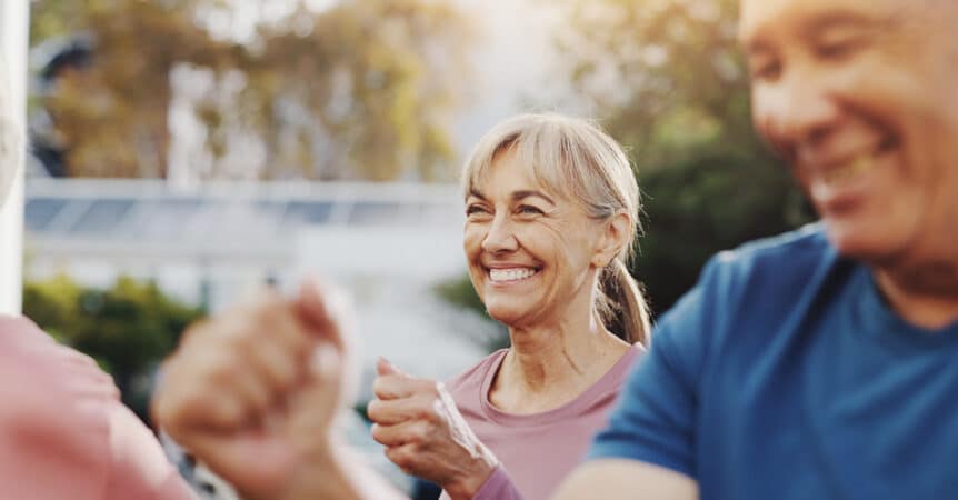 Senior woman smiling and exercising outside on a beautiful day, illustrating the blog topic "Say No to Big New Year Resolutions: Small Lifestyle Choices for Seniors"