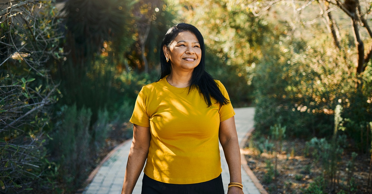 Senior woman enjoying walking on a hiking trail on a sunny day in Austin, Texas